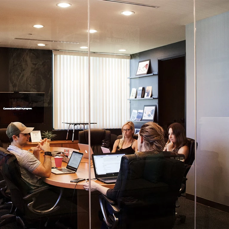 Business team meeting in a conference room discussing strategy.