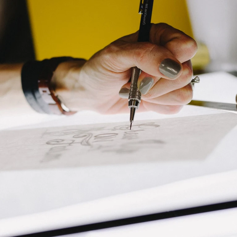 Designer sketching a creative design concept on paper.